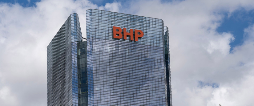 A tall building featuring a prominent sign displaying the letters "BHP" on its exterior.
