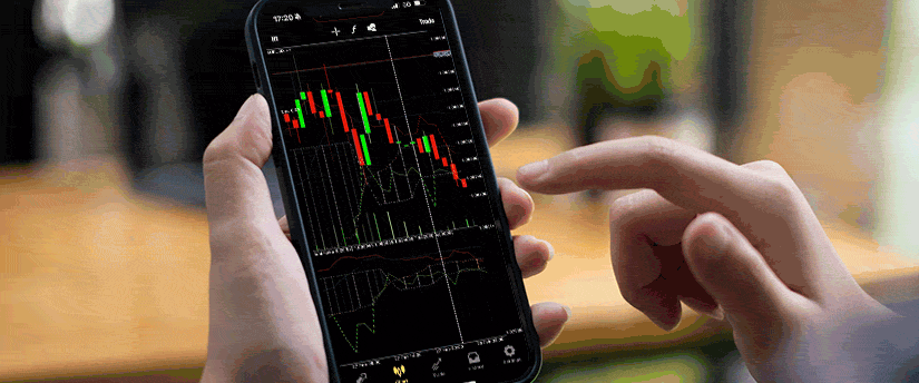 A close-up of a smartphone displaying forex trading charts and tools, illustrating mobile trading convenience.