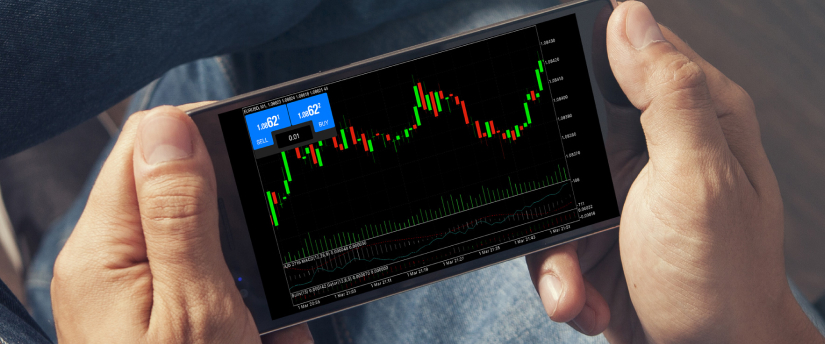 Individual with a smartphone showing a stock market chart, illustrating trends and price movements.